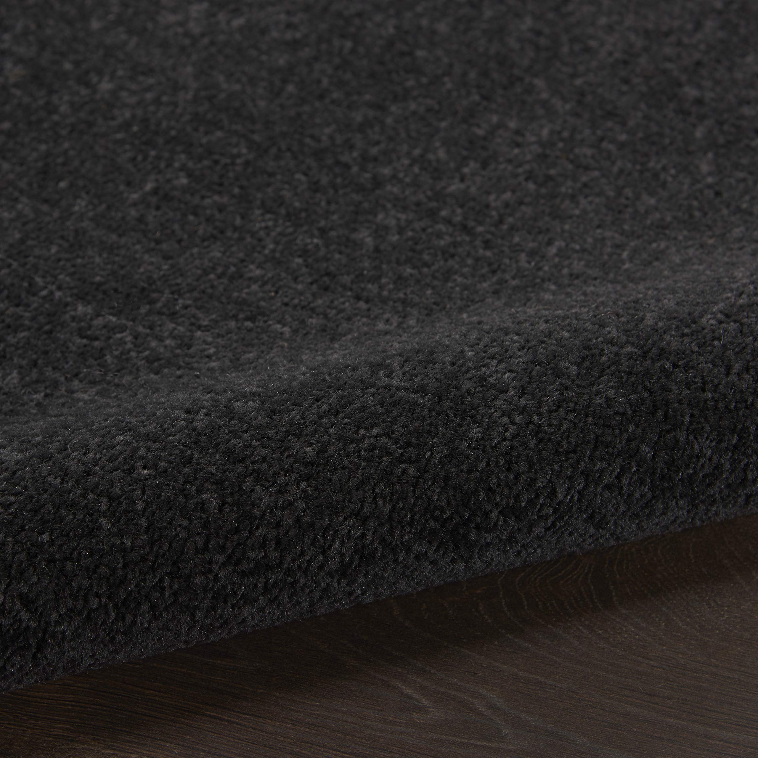 Nourison Essentials Black Runner Rug rolled up for storage