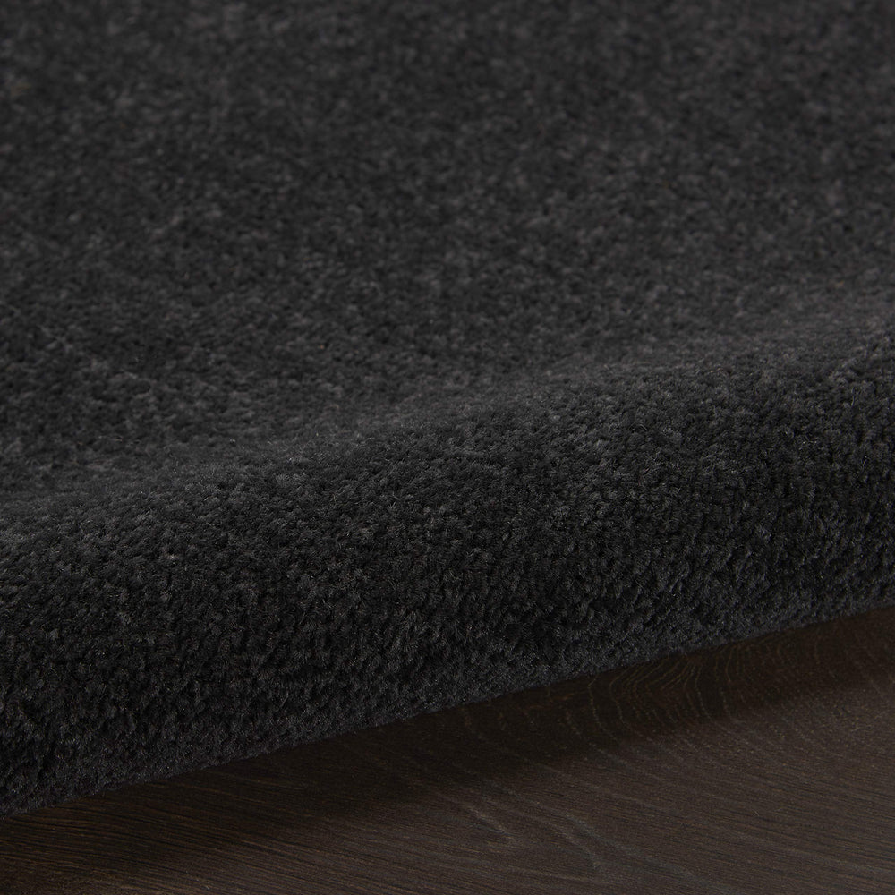 Nourison Essentials Black Runner Rug rolled up for storage