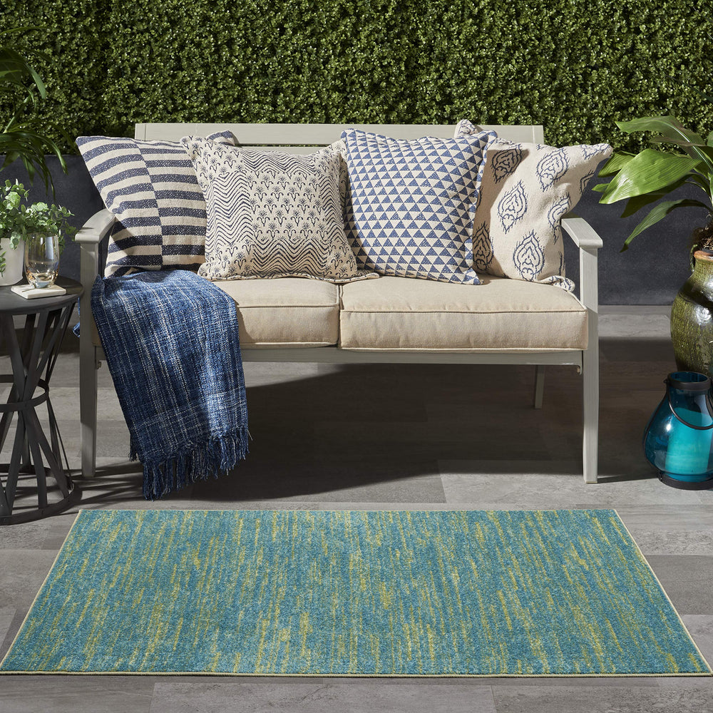 Nourison Essentials Blue Green area rug on patio