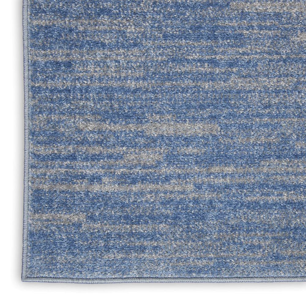 Nourison Essentials Blue Grey Area Rug in living room