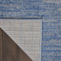 Nourison Essentials Blue Grey Area Rug in outdoor setting