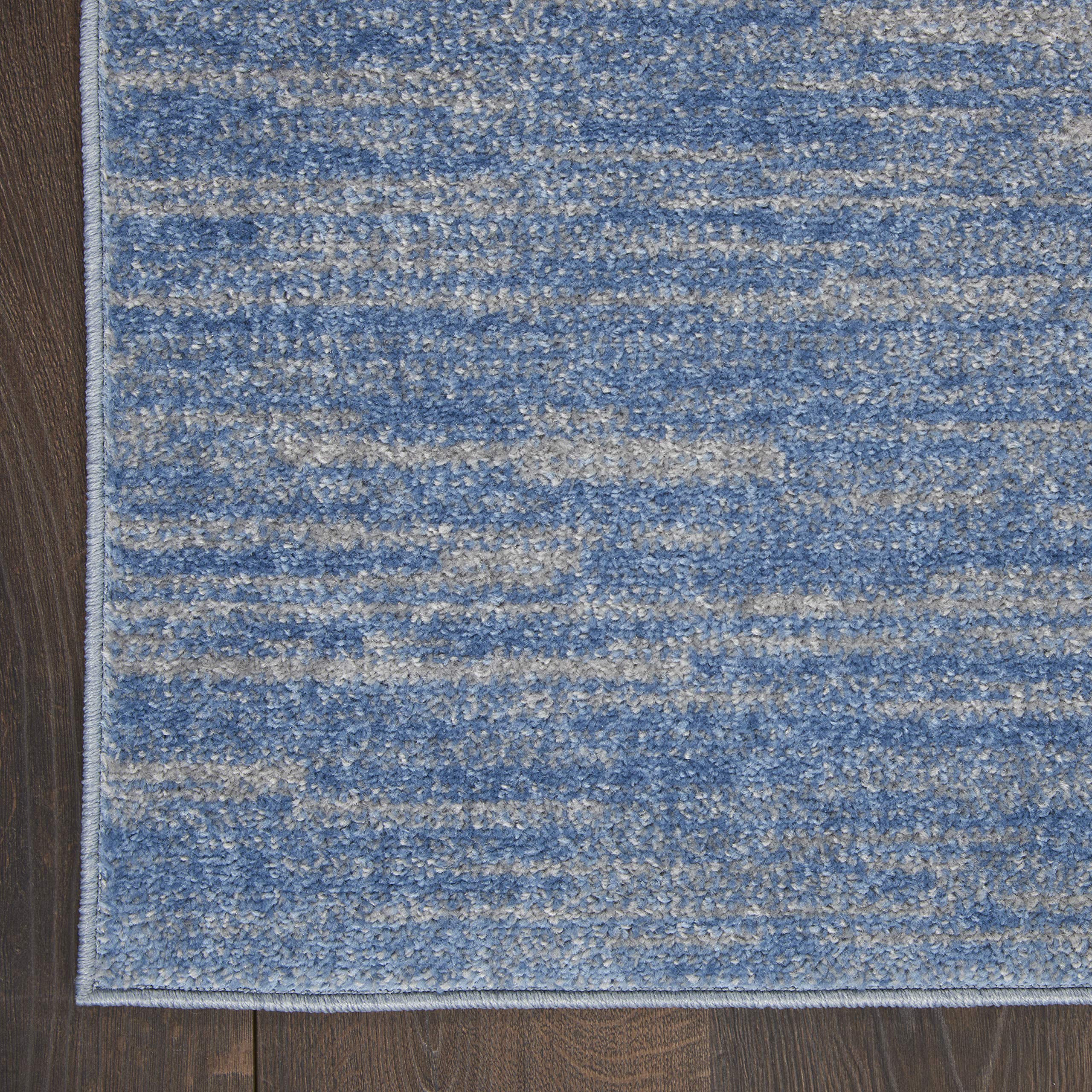 Nourison Essentials Blue Grey Area Rug layered with patterned rug