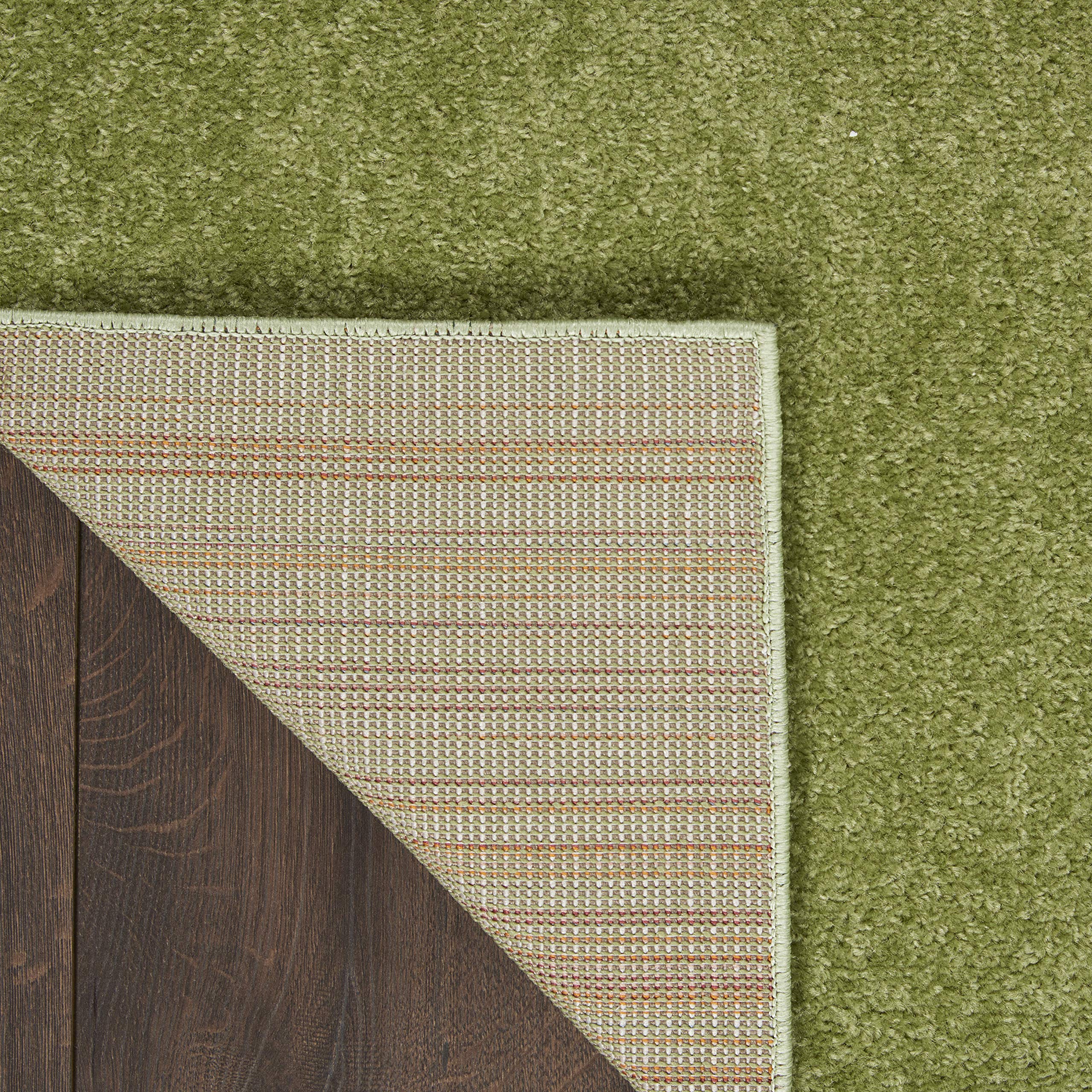 Nourison Essentials Green Area Rug 2' x 6' in living room setting