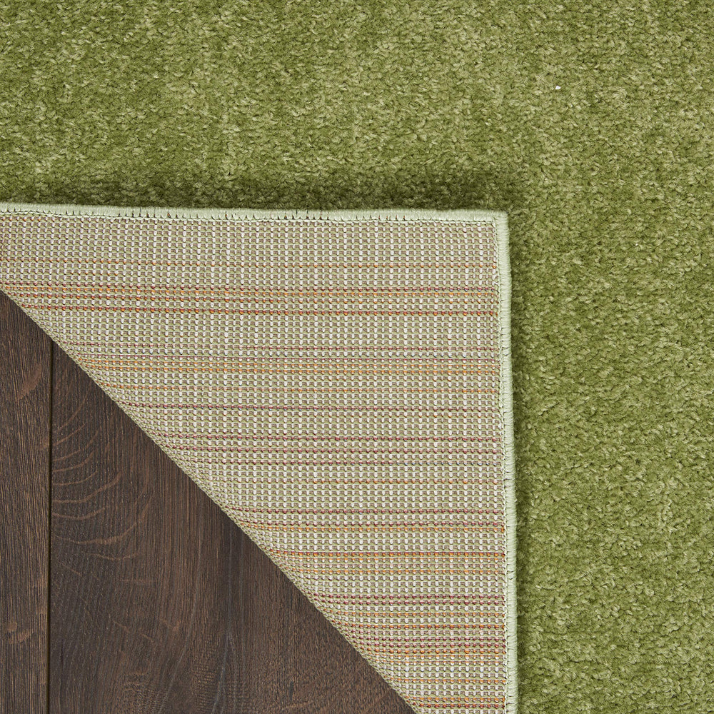 Nourison Essentials Green Area Rug layered with patterned rugs