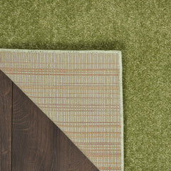 Nourison Essentials Green Area Rug layered with patterned rugs