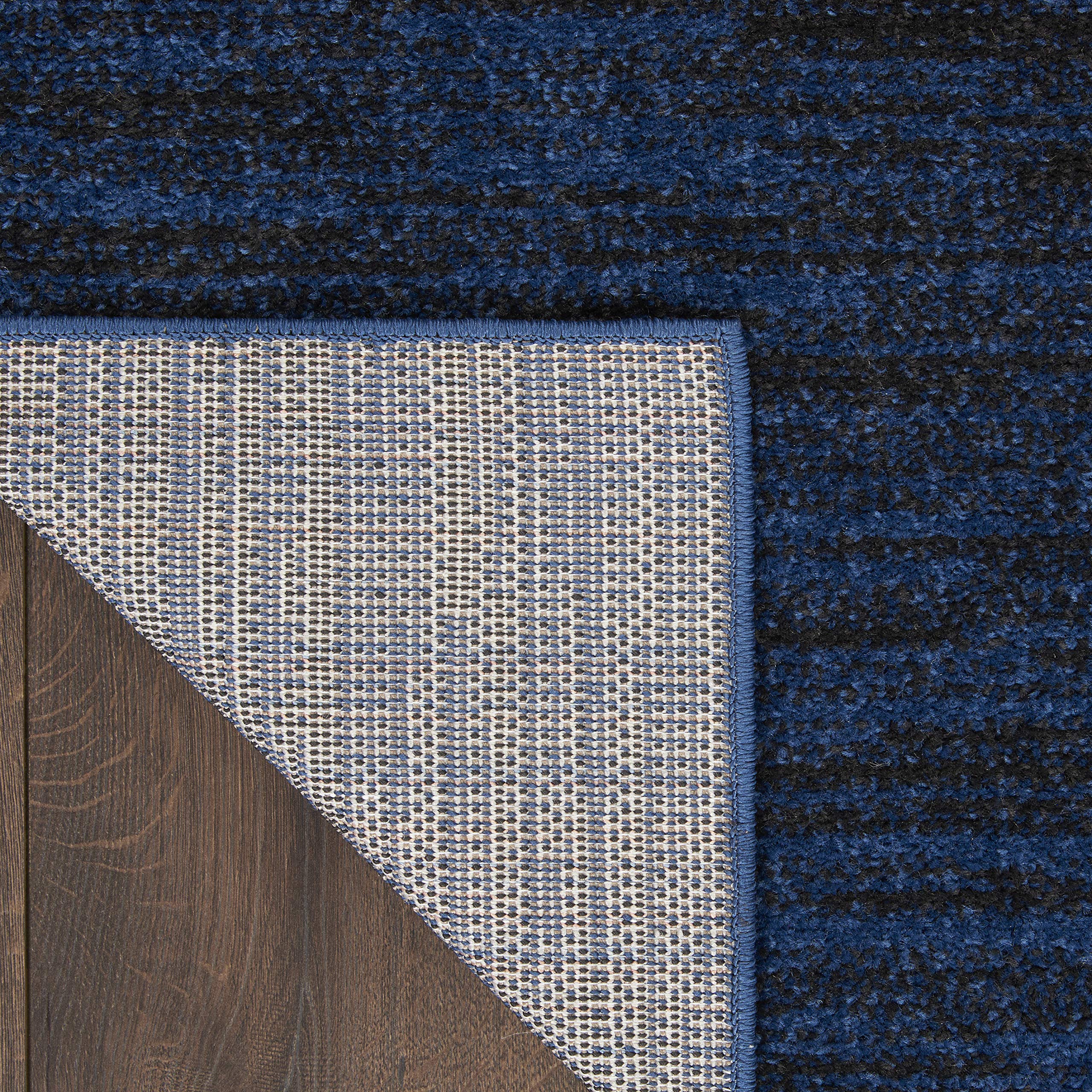 Nourison Essentials Midnight Blue Area Rug in outdoor setting