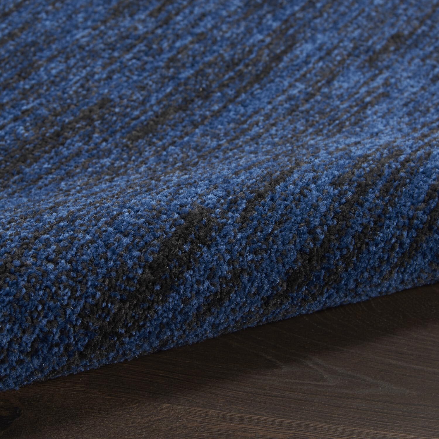 Nourison Essentials Midnight Blue Area Rug rolled up for storage