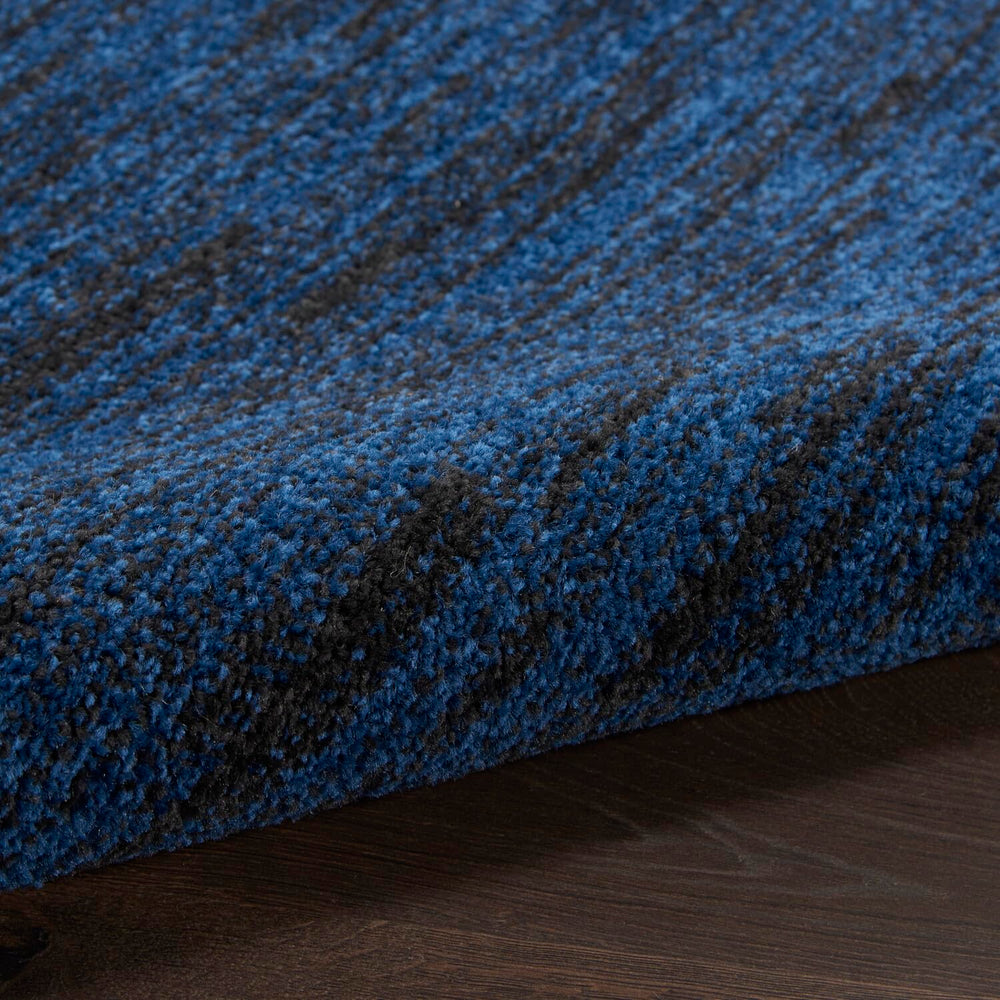 Nourison Essentials Midnight Blue Area Rug rolled up for storage