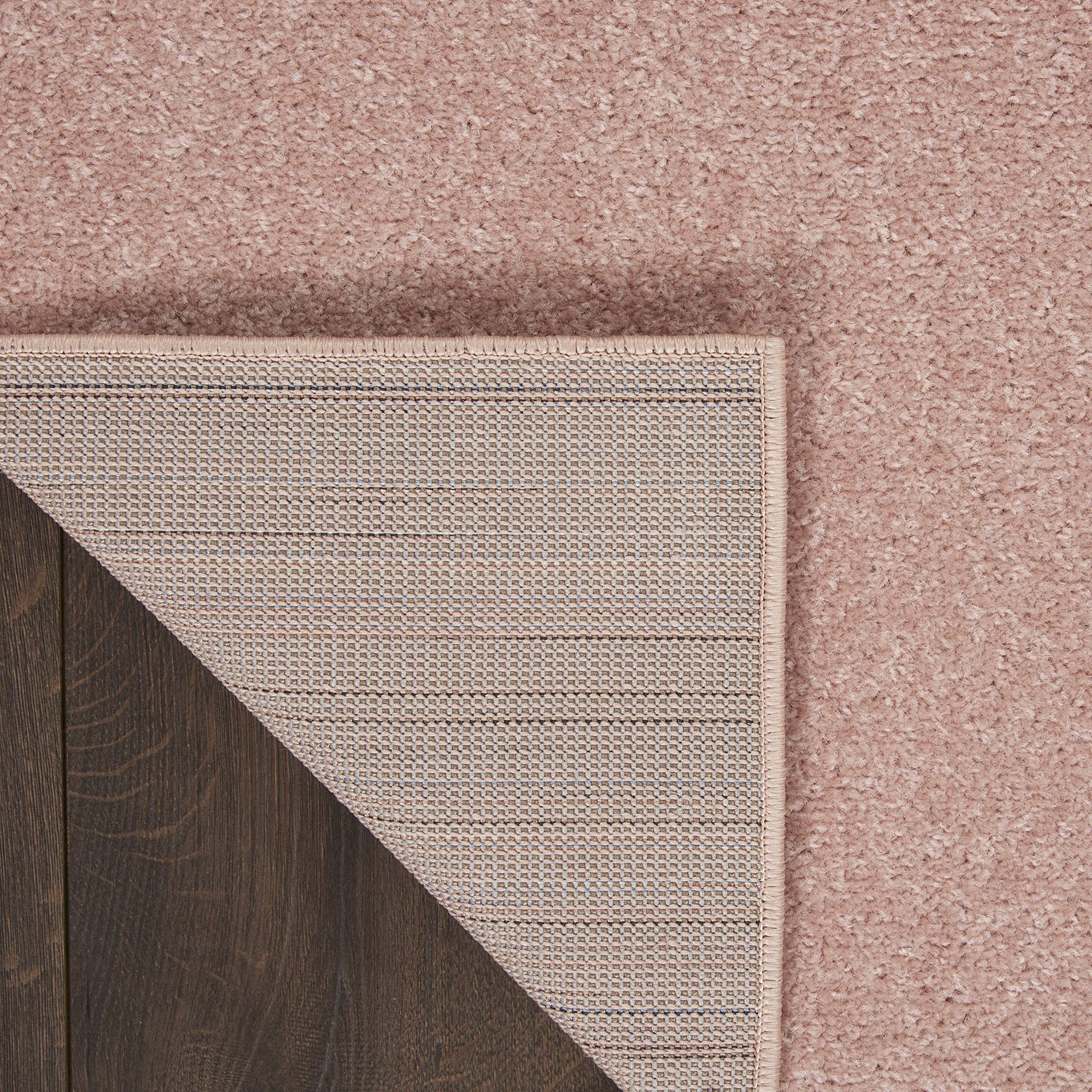 Nourison Essentials Pink Outdoor Rug on patio