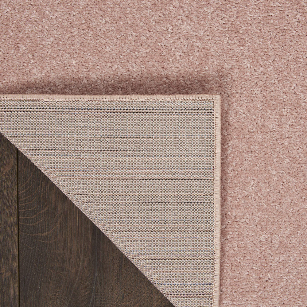 Nourison Essentials Pink Outdoor Rug on patio