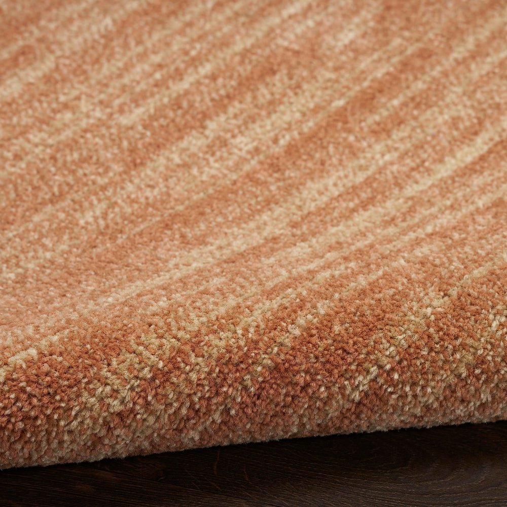 Nourison Essentials Rust Outdoor Rug rolled up for storage