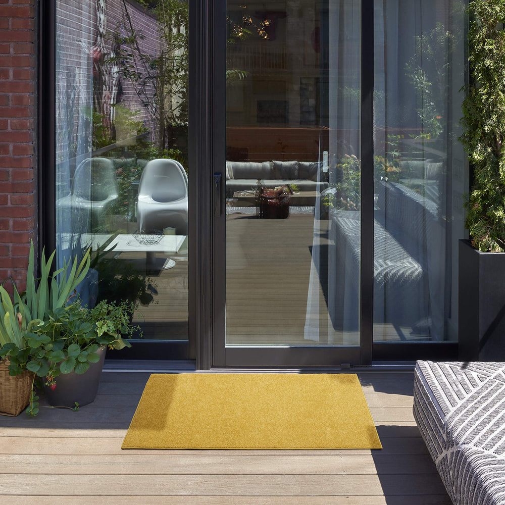 Nourison Essentials Yellow 2' x 4' Rug on patio