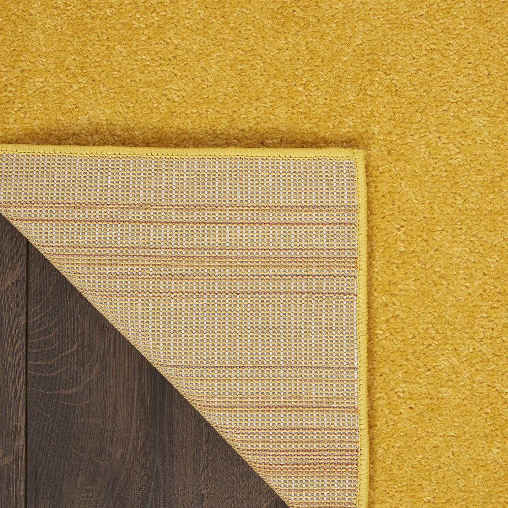 Nourison Essentials Yellow Area Rug in living room setting