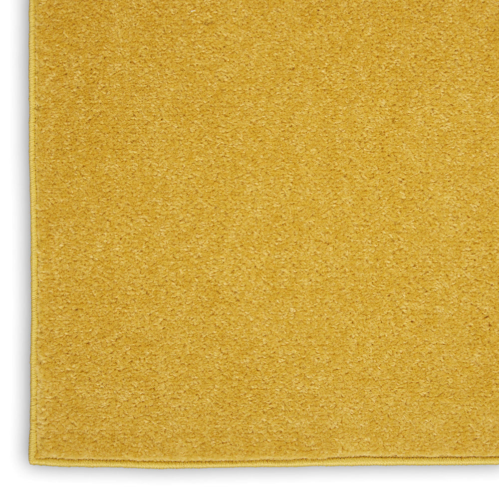 Nourison Essentials Yellow Area Rug near doorway