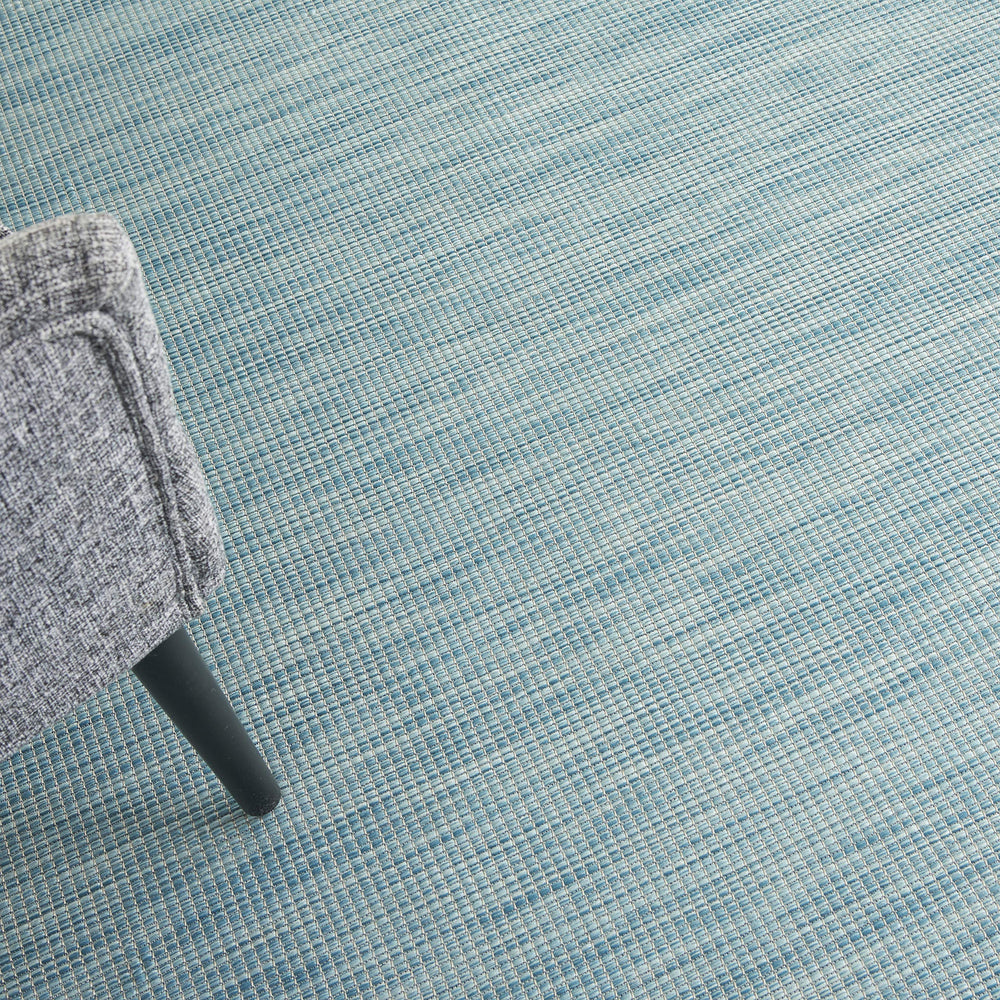 Nourison Positano Aqua outdoor rug in a living room setting