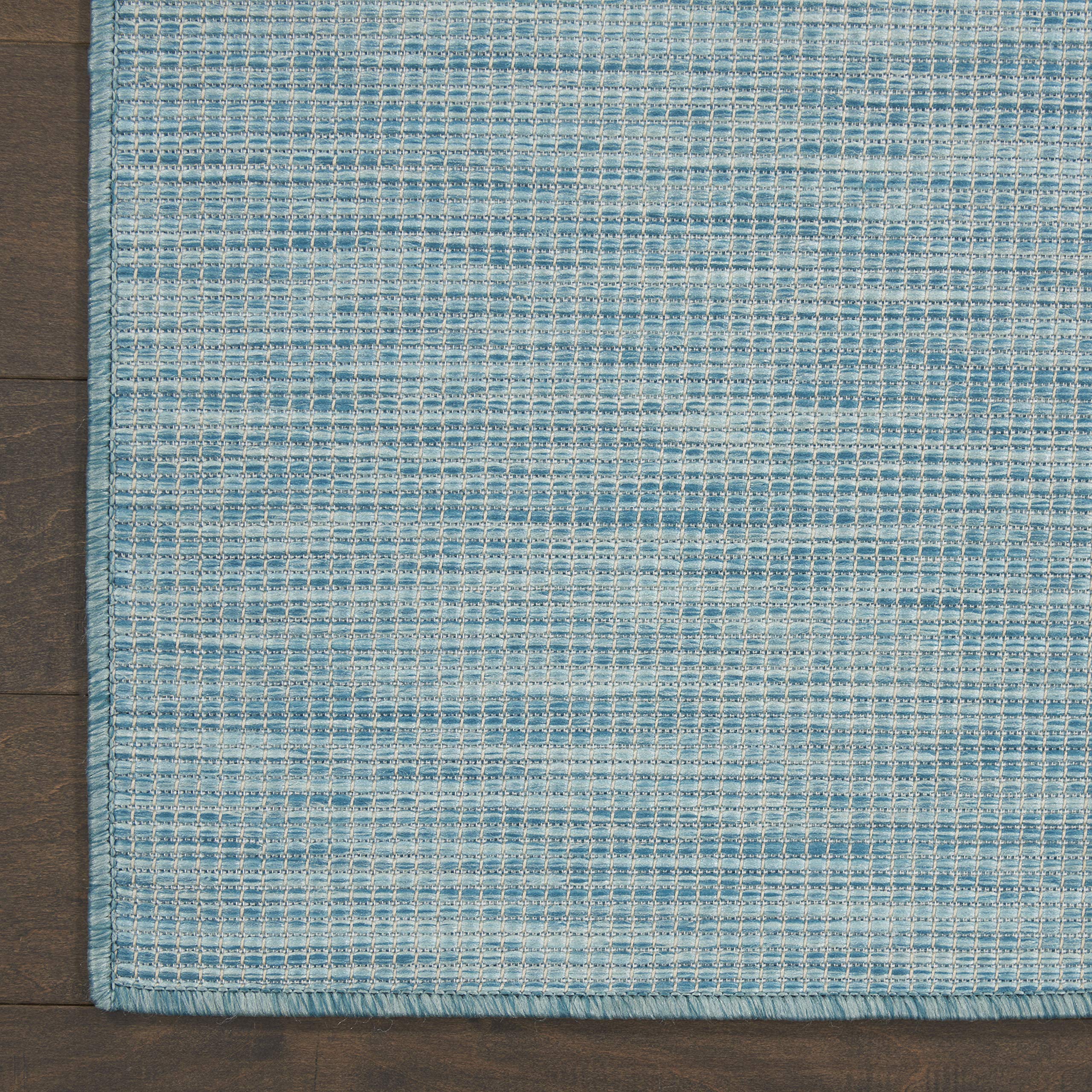 Nourison Positano Aqua rug in a dining area