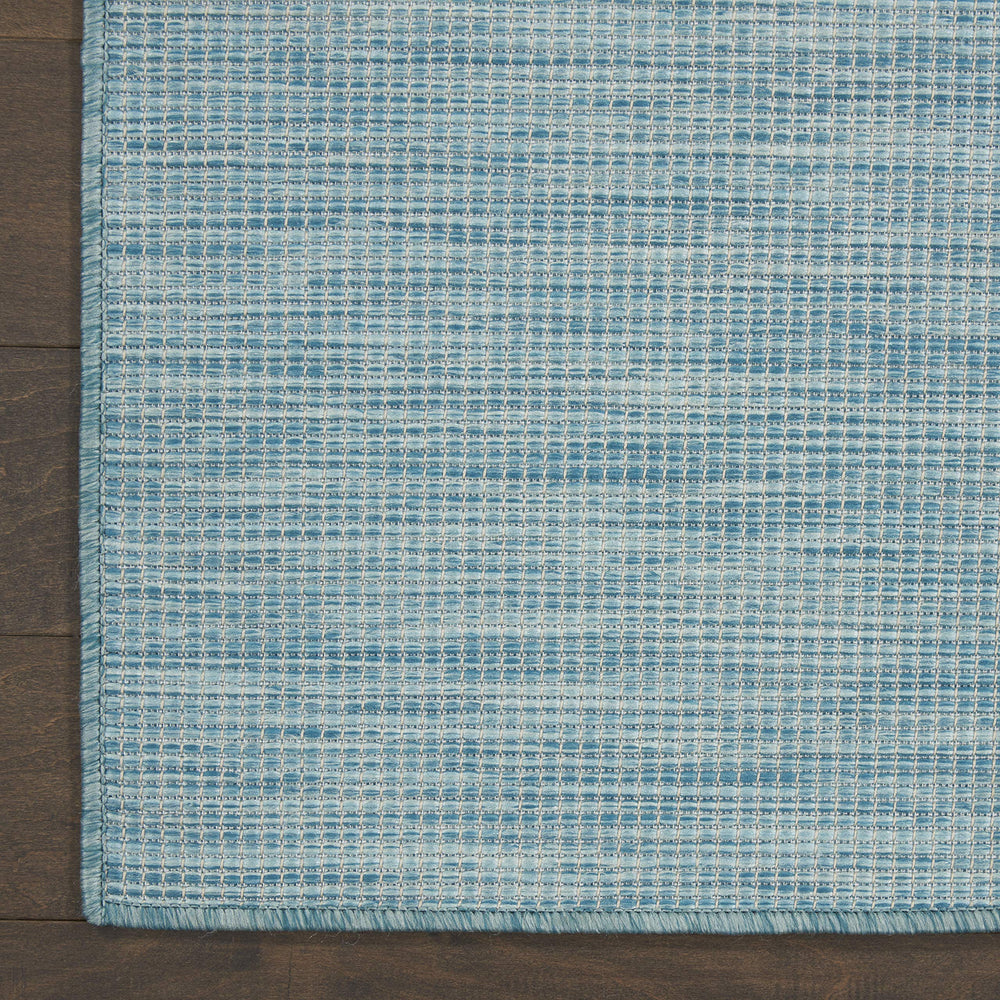 Nourison Positano Aqua rug in a dining area