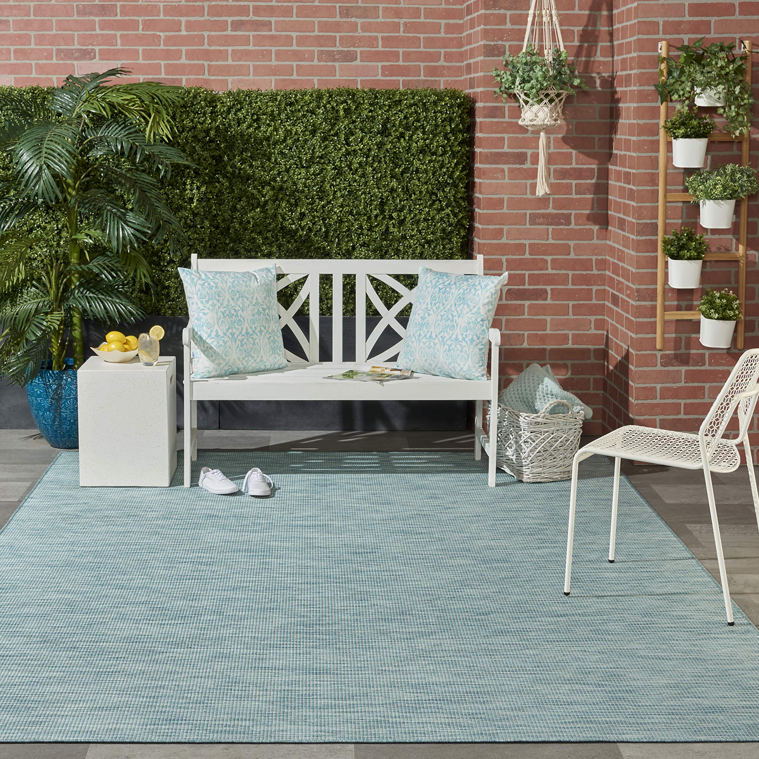 Nourison Positano Aqua rug placed on a patio