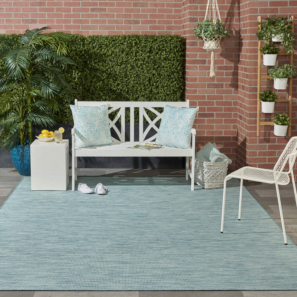 Nourison Positano Aqua rug placed on a patio