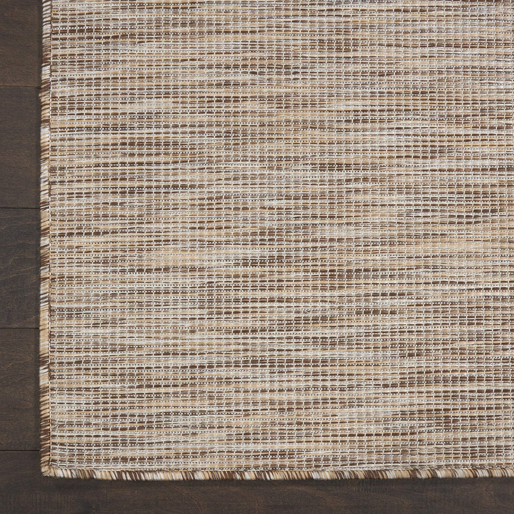 Nourison Positano Beige rug in a patio setting