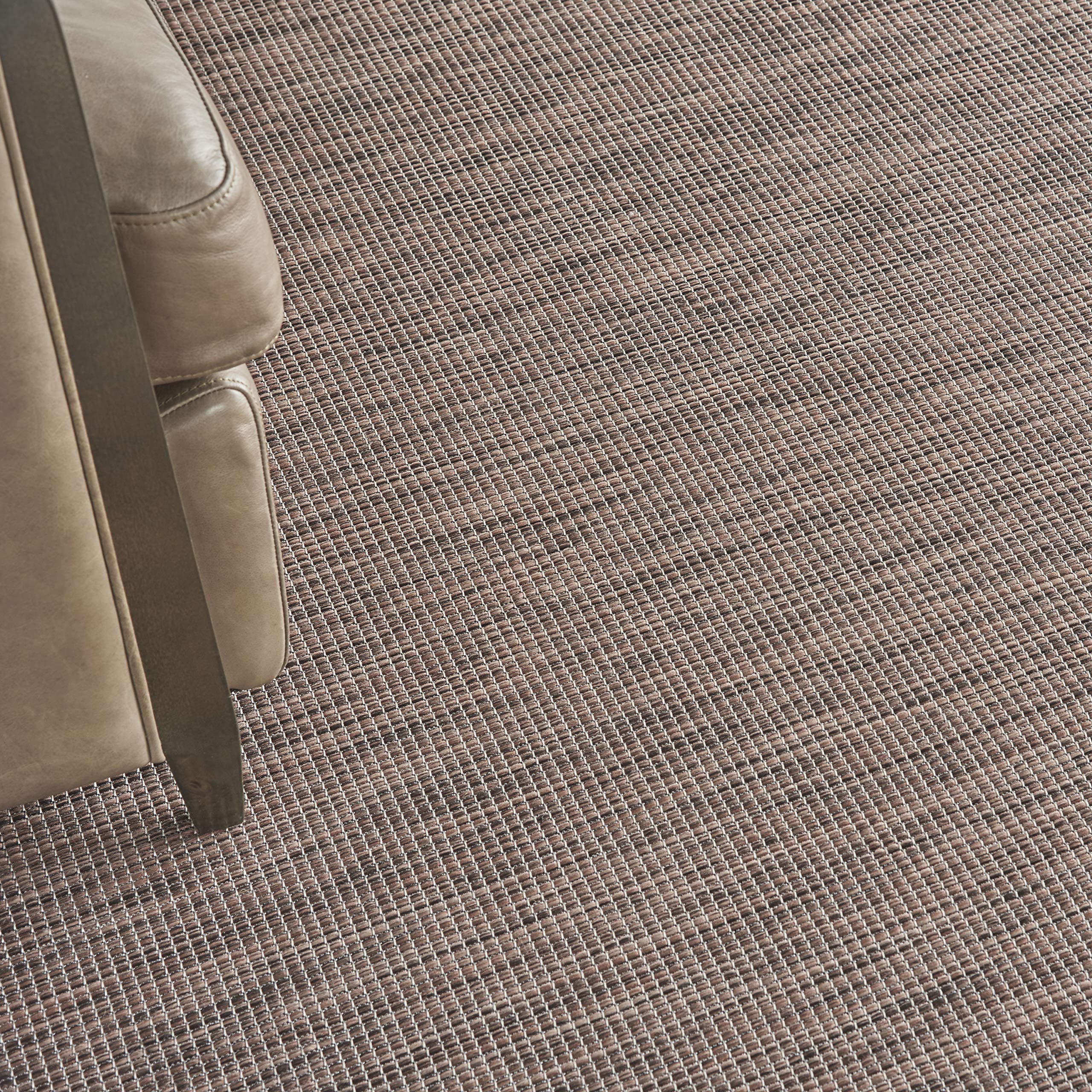 Nourison Positano Natural 2'2" x 12' outdoor rug in a patio setting
