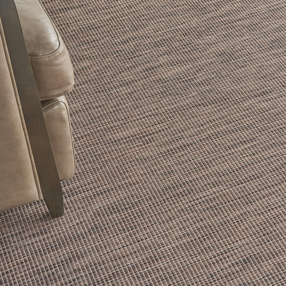 Nourison Positano Natural 2'2" x 12' outdoor rug in a patio setting