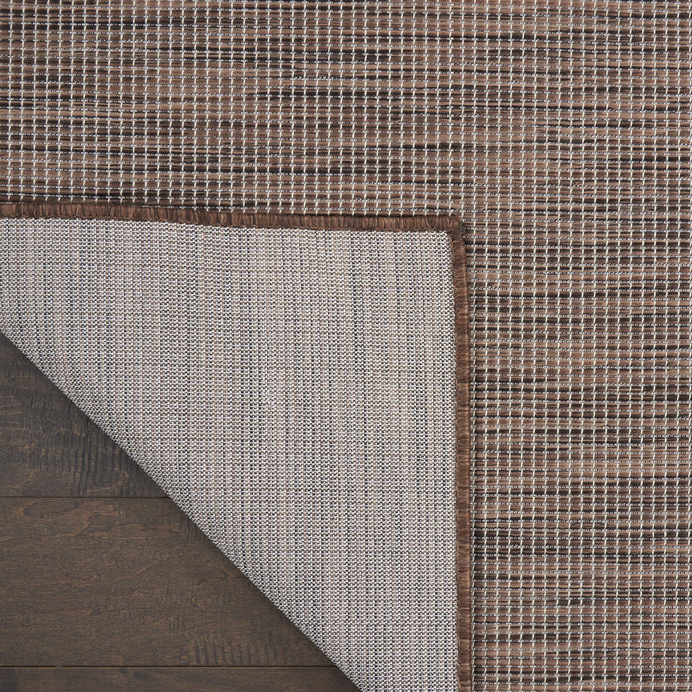 Nourison Positano Natural outdoor rug on a deck