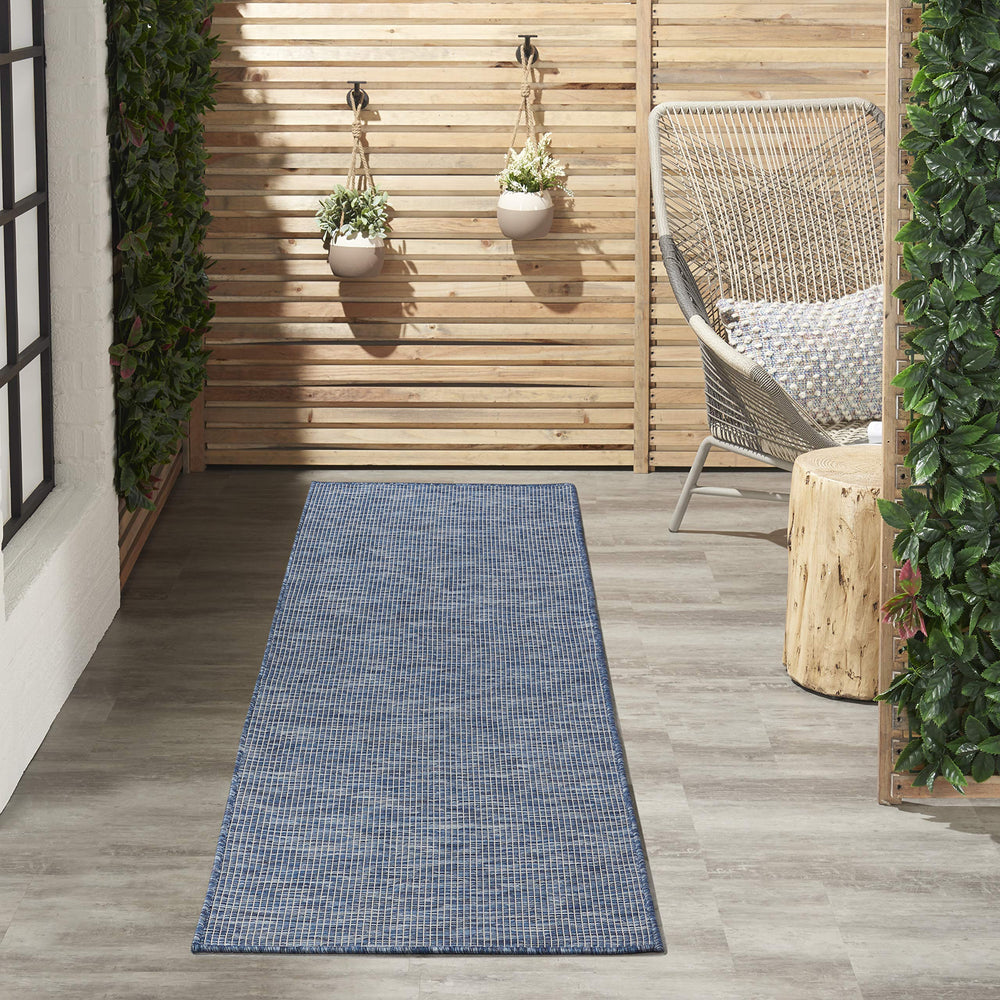 Nourison Positano Navy Blue outdoor rug in a dining area