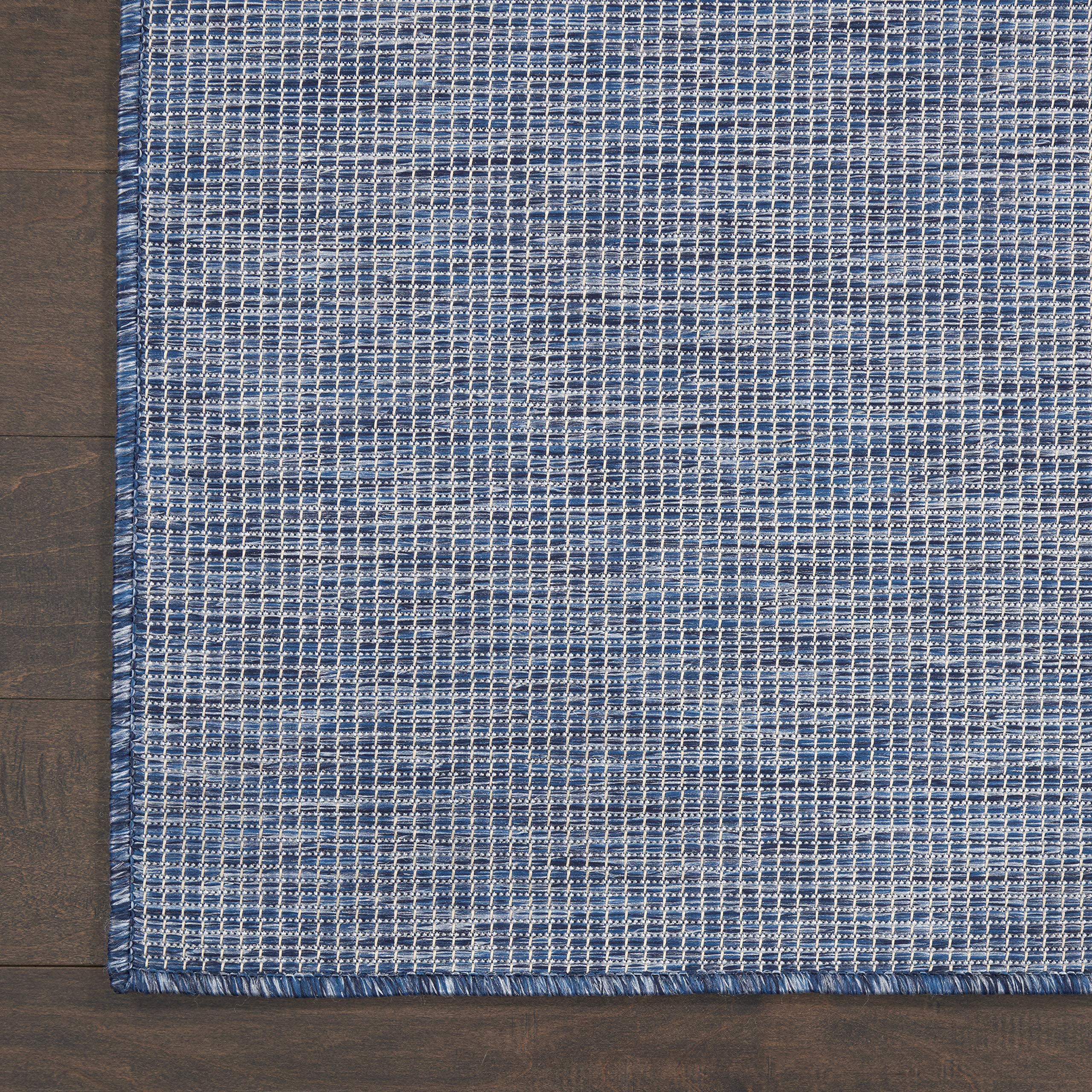Nourison Positano Navy Blue outdoor rug in a patio setting