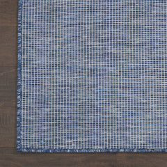Nourison Positano Navy Blue outdoor rug in a patio setting