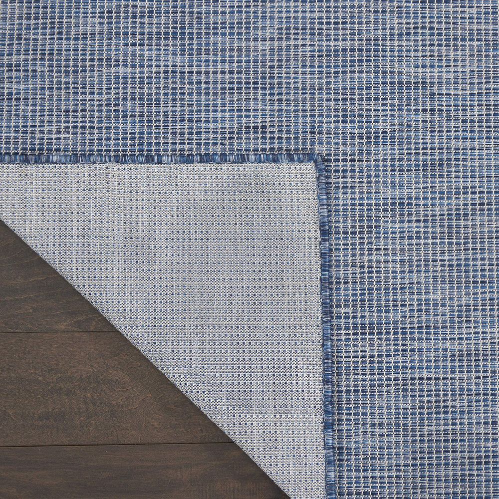 Nourison Positano Navy Blue outdoor rug rolled up for storage