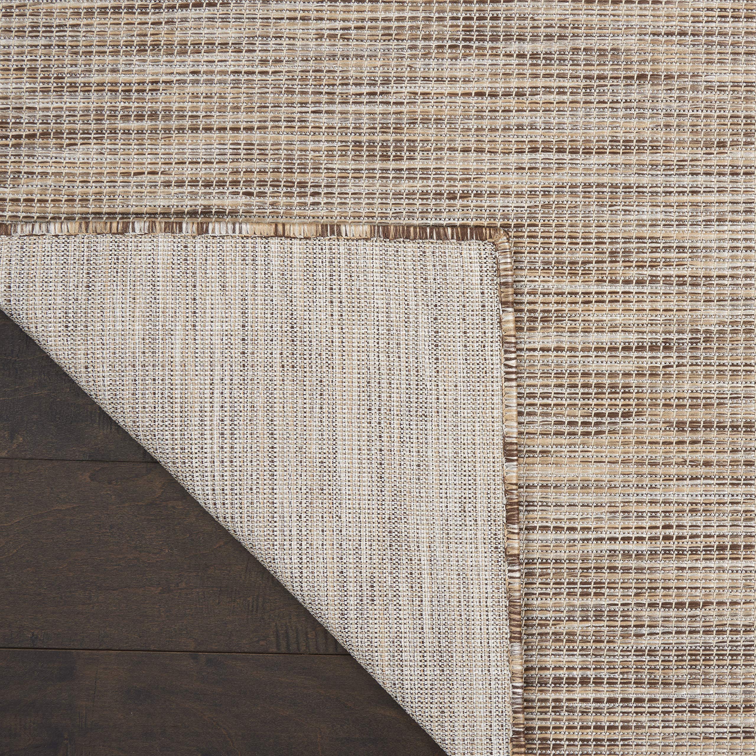 Nourison Positano rug layered with patterned rugs