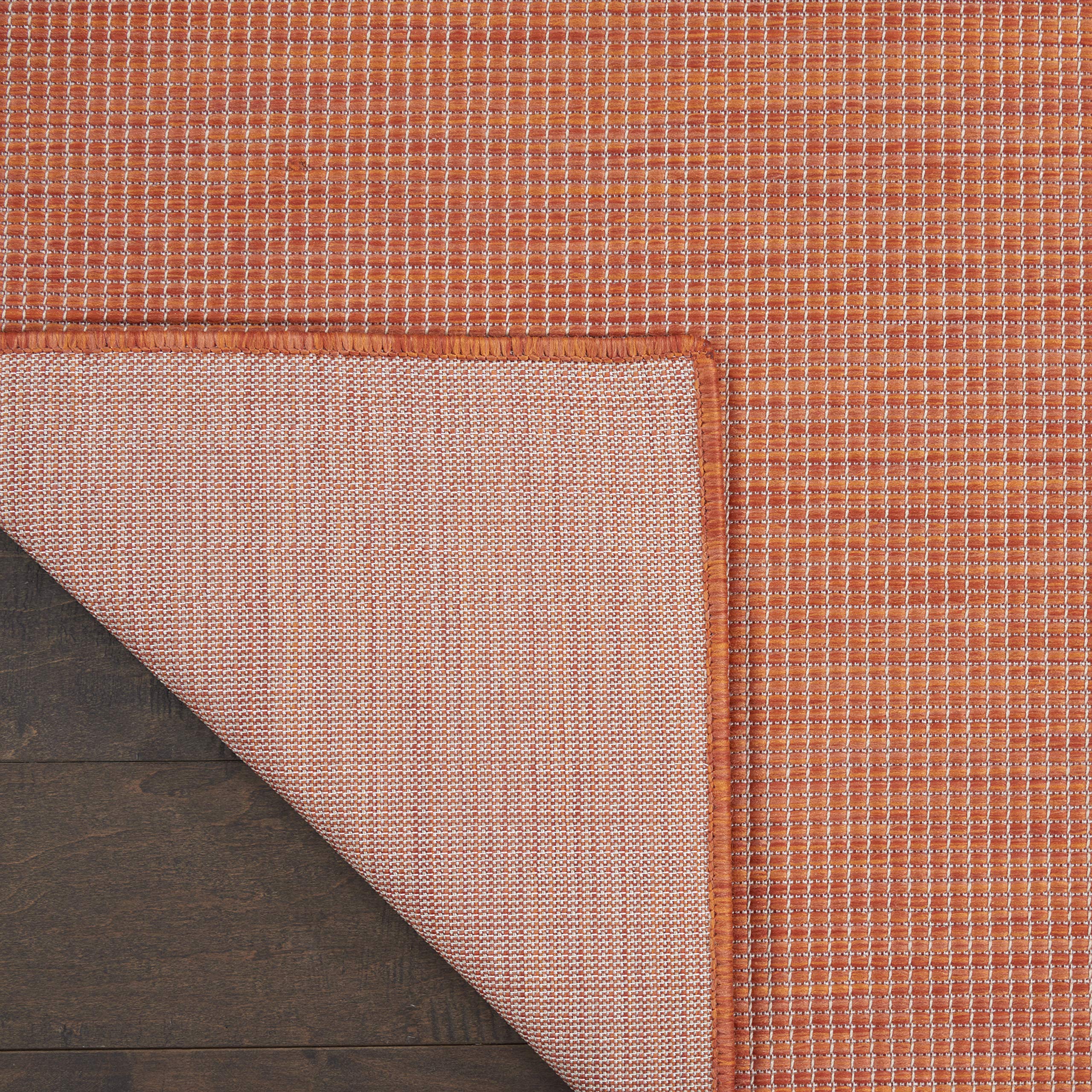 Nourison Positano Terracotta Outdoor Runner Rug in a dining room