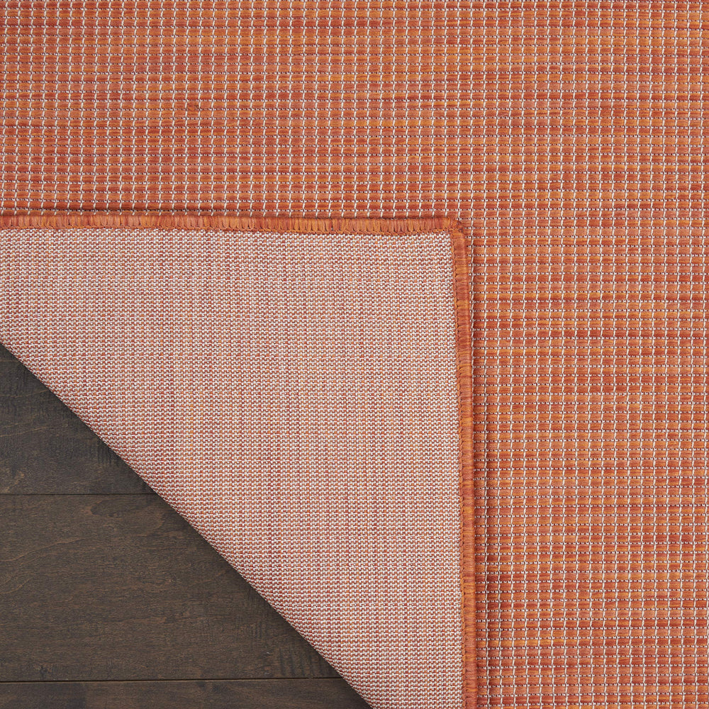 Nourison Positano Terracotta Outdoor Runner Rug in a dining room