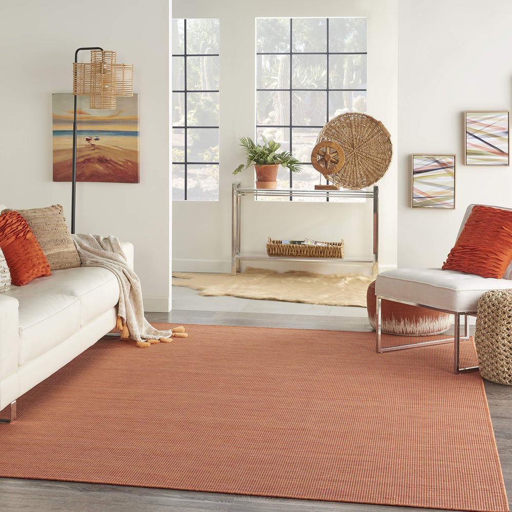 Nourison Positano Terracotta Outdoor Runner Rug in a patio setting
