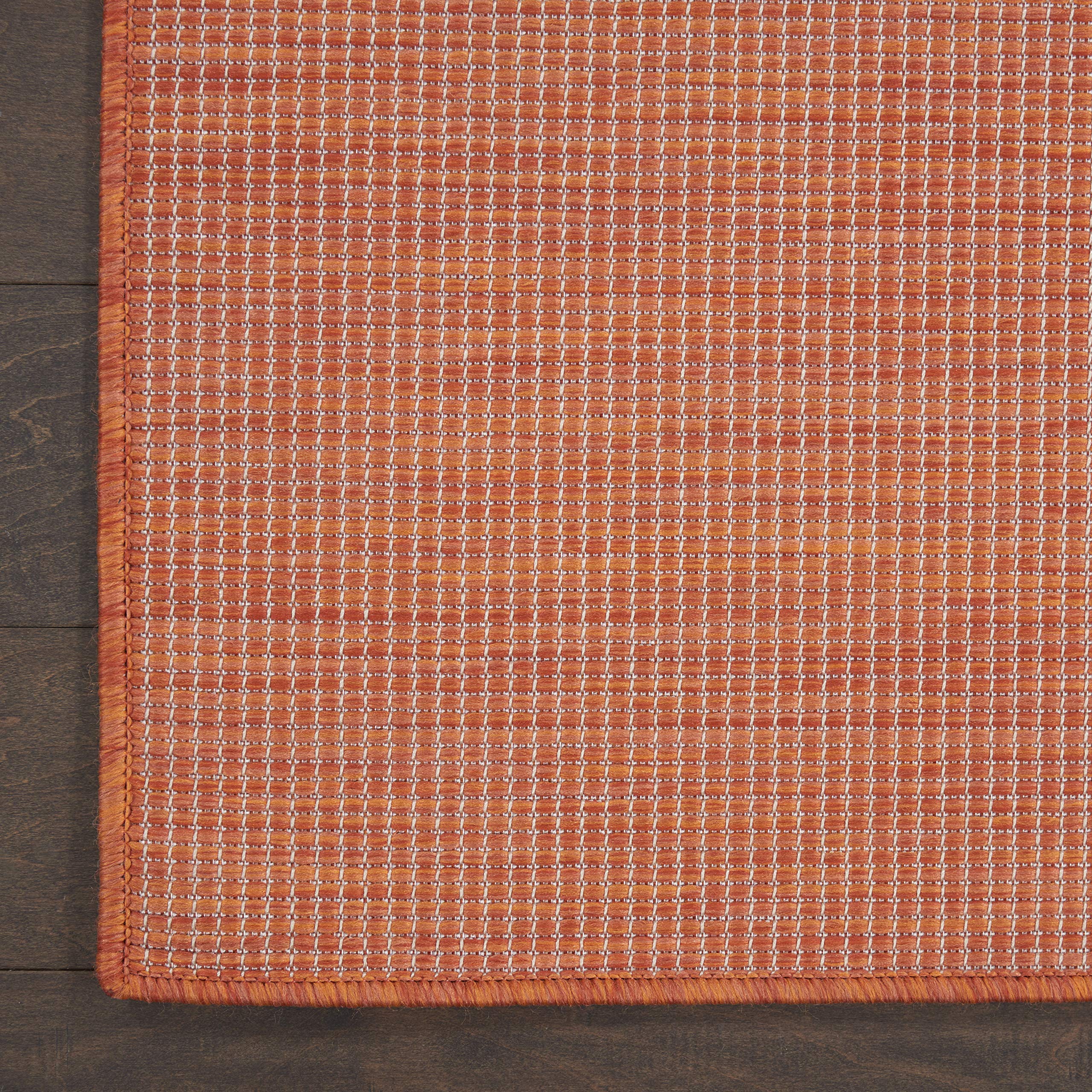 Nourison Positano Terracotta Outdoor Runner Rug on a porch