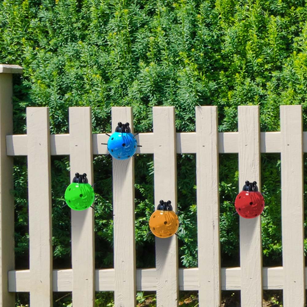 OBTANIM colorful ladybug sculptures in a flower bed