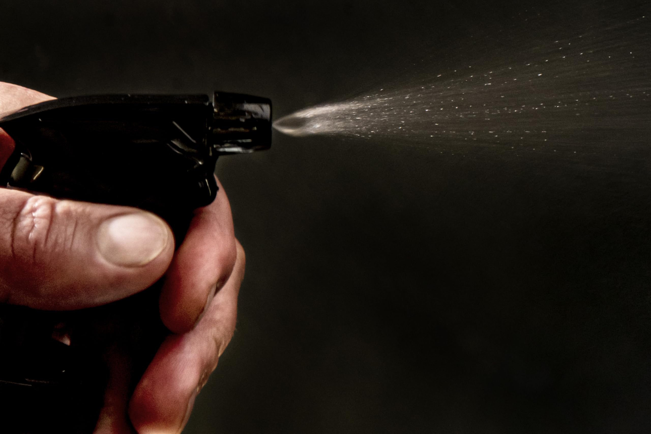 Oklahoma Joe's 2-in-1 Spray Bottle in use, injecting marinade into meat