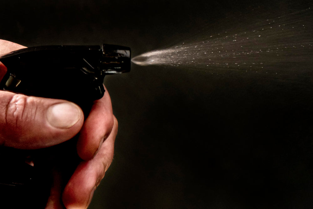Oklahoma Joe's 2-in-1 Spray Bottle in use, injecting marinade into meat