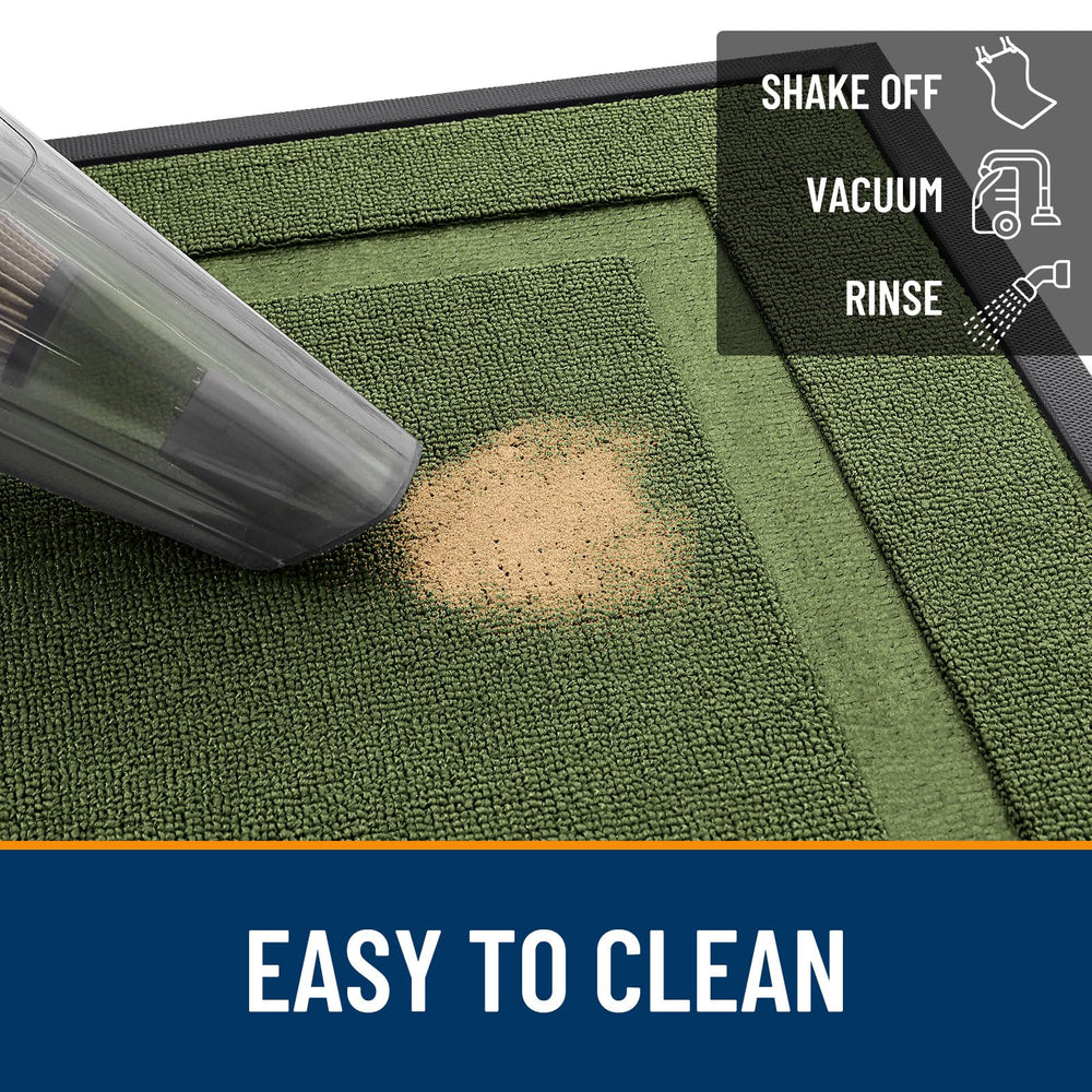 OLANLY door mat being cleaned with a garden hose