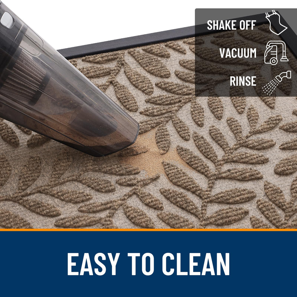 OLANLY Door Mat being cleaned with a hose
