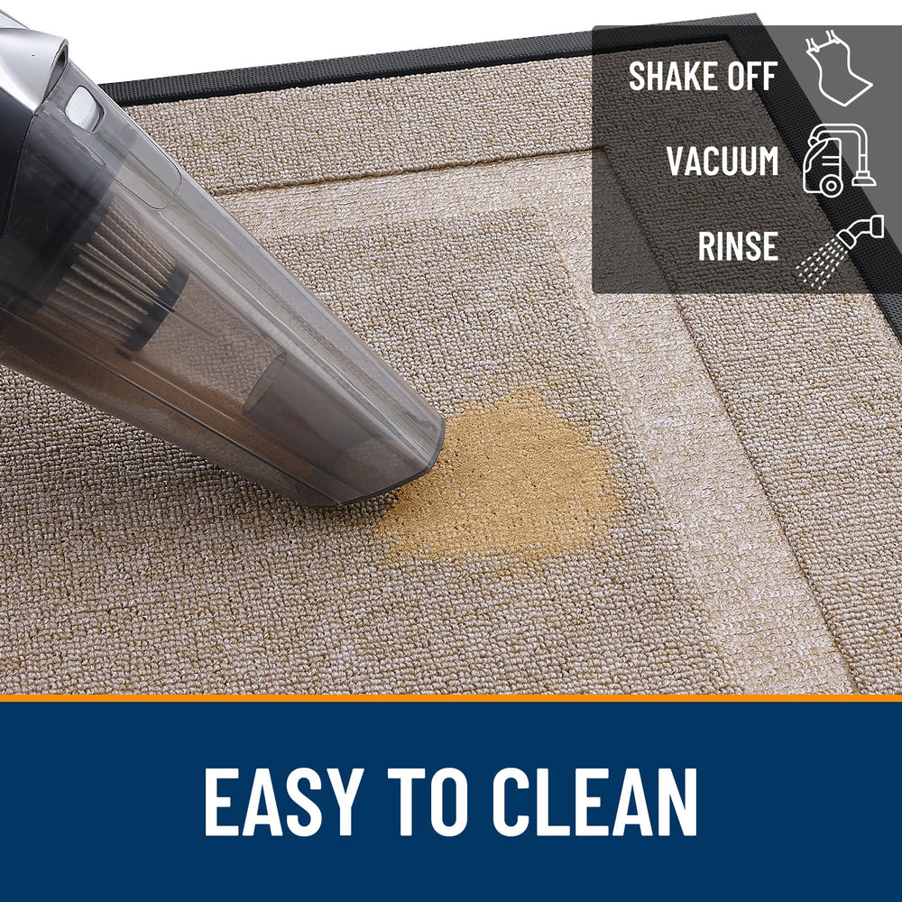 OLANLY doormat being cleaned with a garden hose