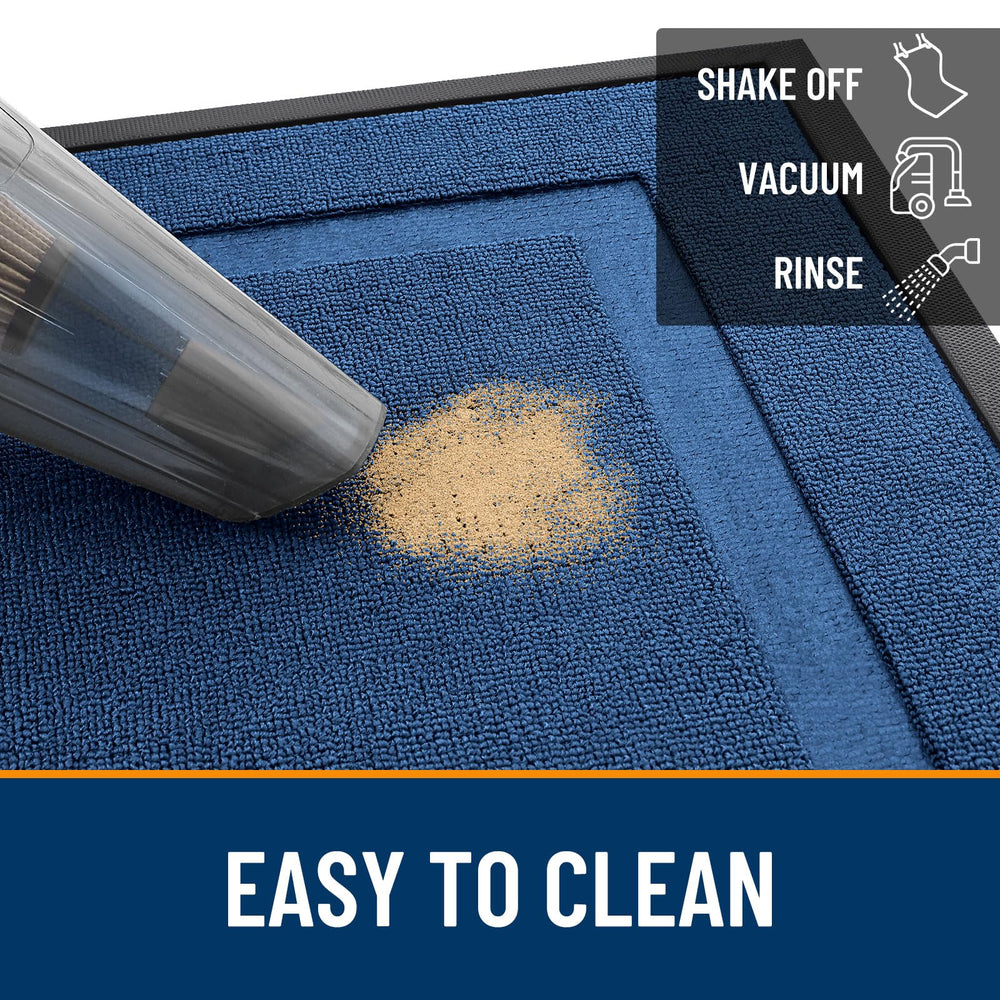 OLANLY doormat being cleaned with garden hose