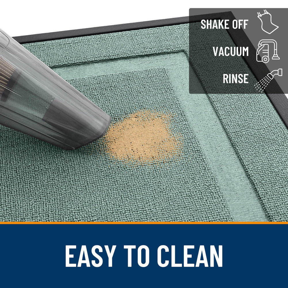 OLANLY Front Door Mat being cleaned with a garden hose