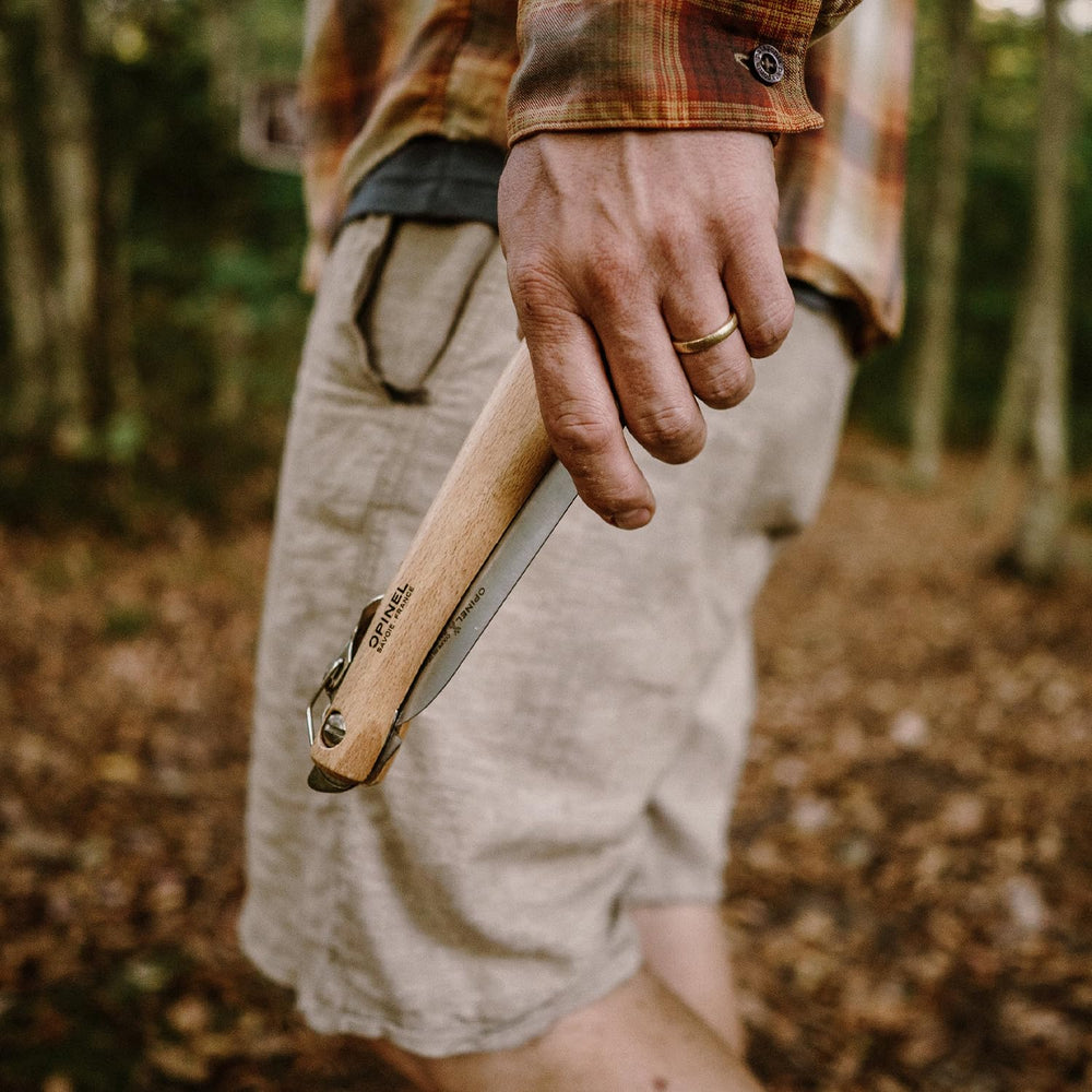 OPINEL Folding Saw No12 displayed with garden tools