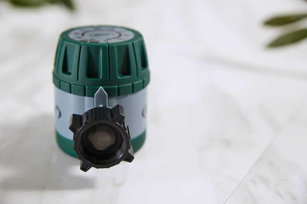 Orbit 3-Pack Mechanical Watering Timer set on a garden table