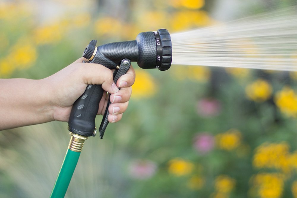 Orbit Front Trigger Nozzle in use watering plants in a garden