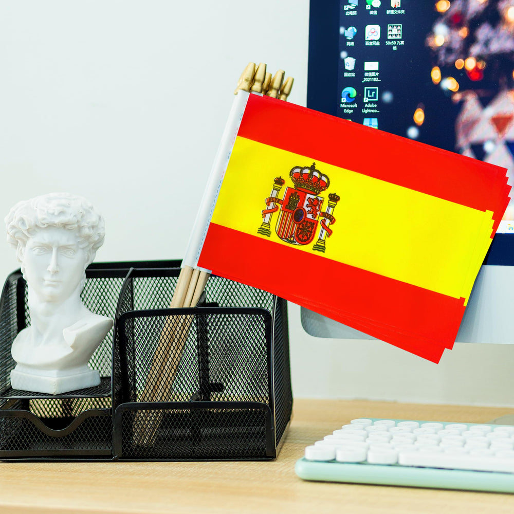 Pack of 12 TSMD Spain Stick Flags on a table