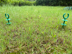 Package of garden hose guide stakes on display