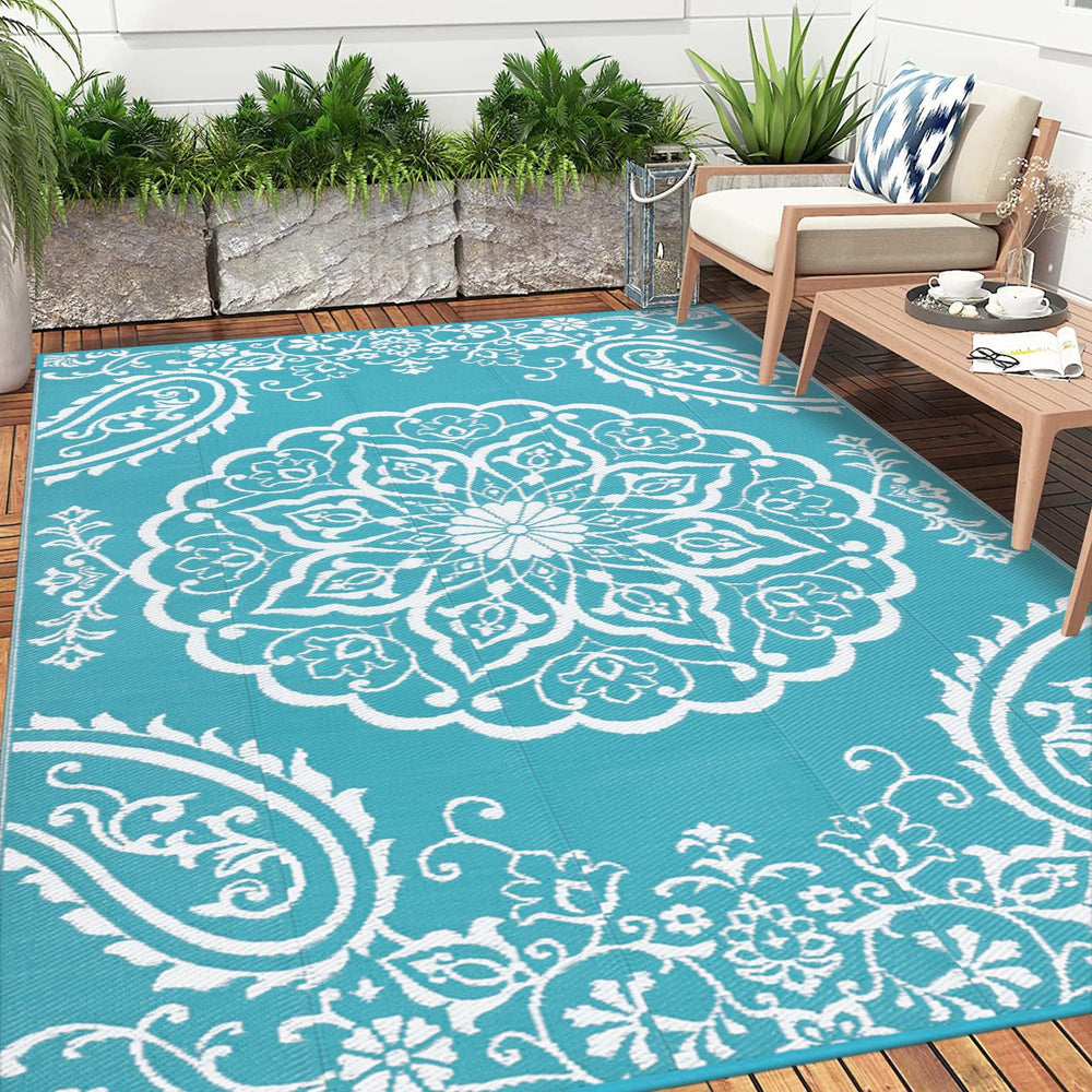 Pauwer Outdoor Rug laid out in a garden setting